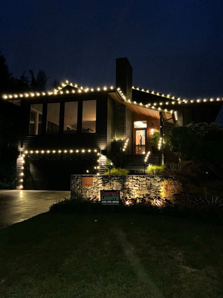 Modern home with warm white roofline and landscape lighting