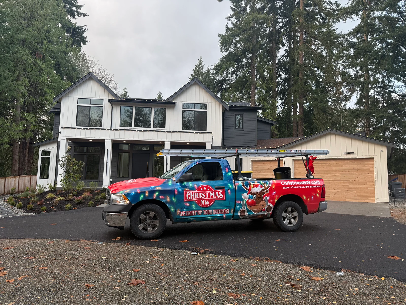 Christmas Northwest's wrapped Ram 1500 at a home with warm-white roofline lights